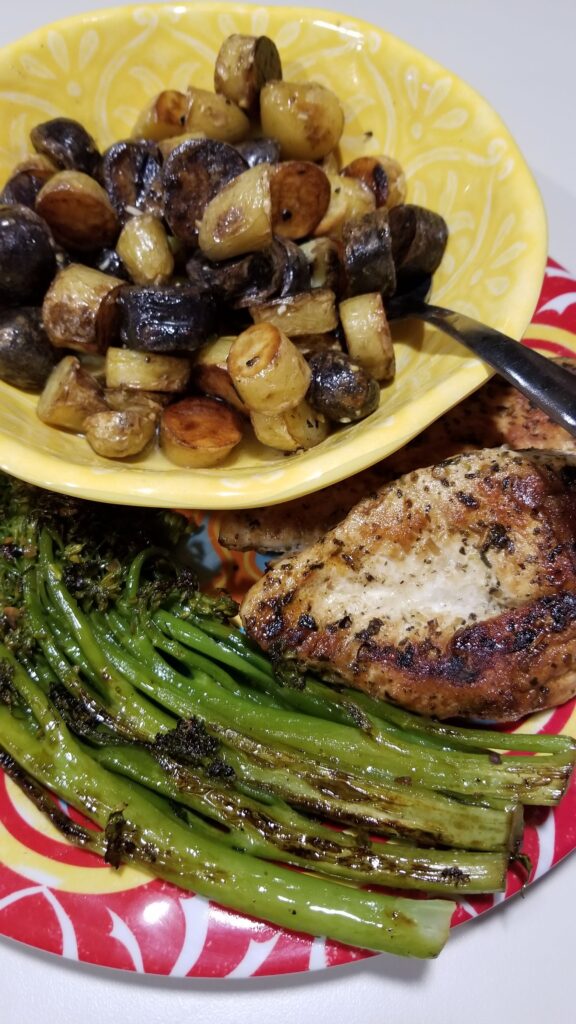 Grilled chicken with roasted fingerling potatoes and broccolini cooked while traveling
