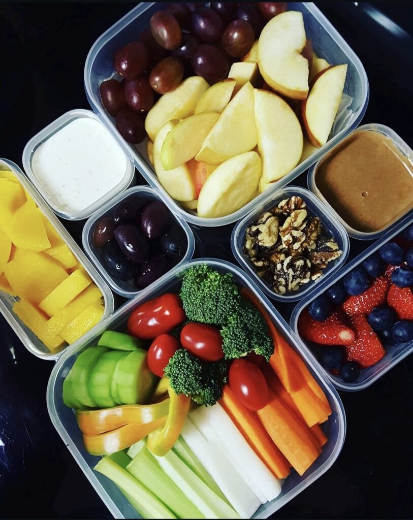 Bento box travel meals with fresh fruit, vegetables, nuts and dipping sauces